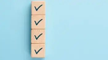 Image of 4 blocks with check marks stacked