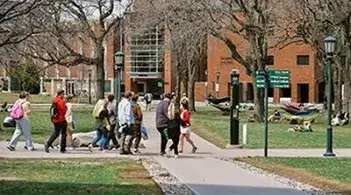 Students walking across a university campus.