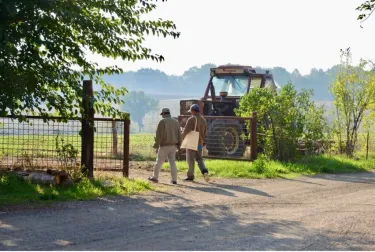 Two people walking together in farm field