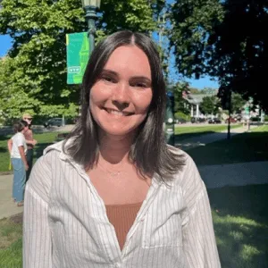 Annabel, smiling while out on a blue-sky day on UVM green