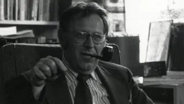 A dated black and white photo of Samuel B. Hand, a cigar in his mouth.