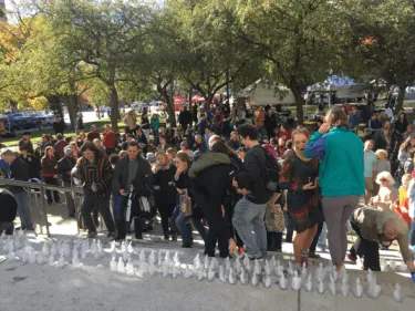 Large group of people watching ice sculpture
