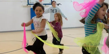 Group of kids running in a basketball court