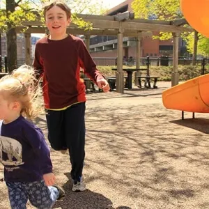 Kids running around in outdoor playing ground