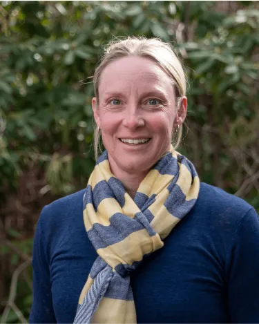Janet in blue sweater with blue and yellow scarf