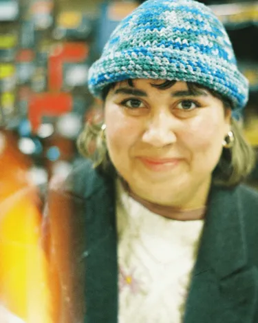 Krizzi in black jacket with blue cap taken with analogue camera