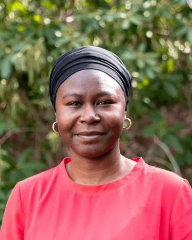 Saadatu in red shirt with black headscarf