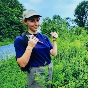 Veronica taking plant cuttings in the field