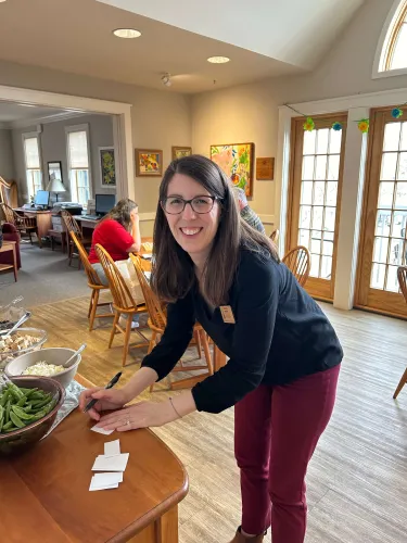 Kristie Grover writing at a table