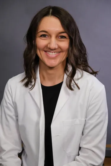 A person wearing a white coat