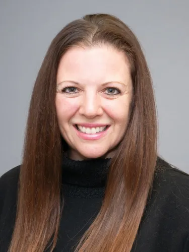 A person with long hair wearing a dark shirt
