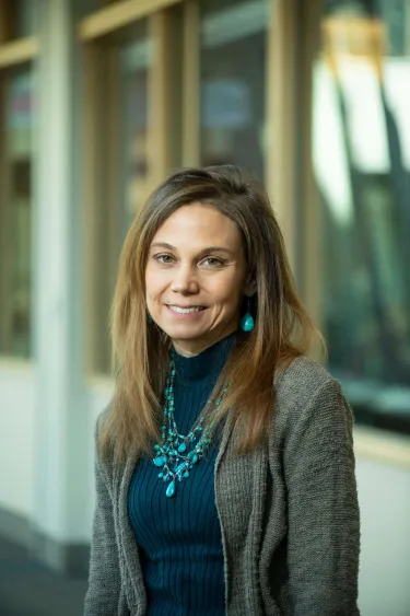 A person wearing a sweater and a blazer