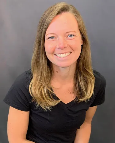 A person with long hair wearing a t shirt