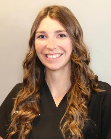 A person with long hair wearing a dark shirt