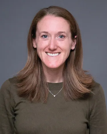A person wearing a shirt and a necklace