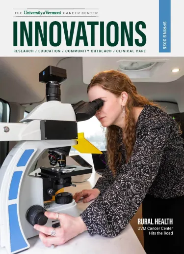 Cover of UVMCC's Innovations: A woman looks into a microscope inside the UVM Cancer Center's biomobile van