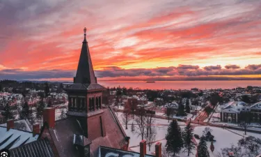 winter sunset over buildings and lake