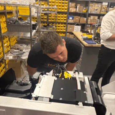 Student looks at an engineering prototype