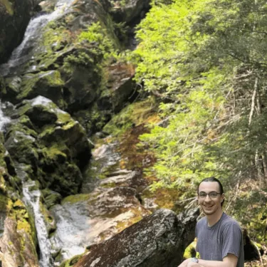 Headshot of Jackson in front of waterfall