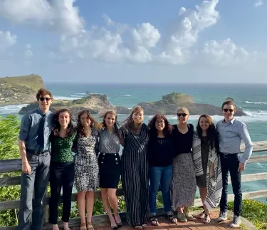 Group of CDAE students posing in front of ocean overlook
