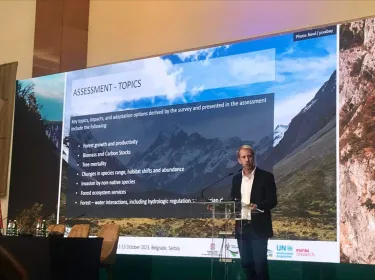 Man stands in front of screen.