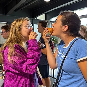 two girls eating croissants
