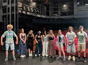 students standing on NYC stage