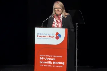 Person speaking at a podium. 