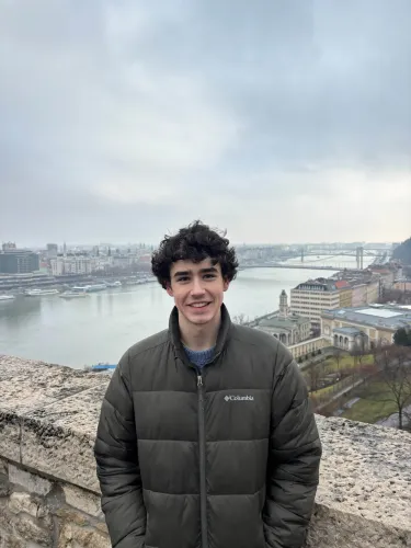 Student in front of a European canal 