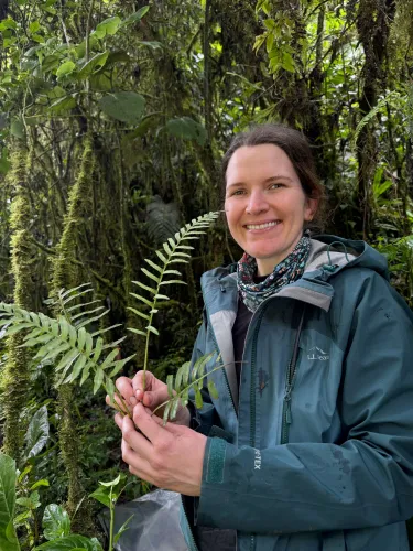 Woman holding a fern