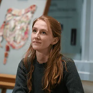 a person in front of a piece of art