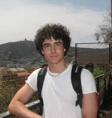 Man in front of a backdrop of Spanish town