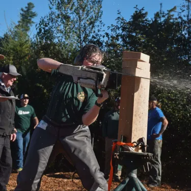 Alannah using a chainsaw at a Timbersports event.