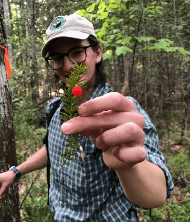 A man holding up a plant specimen