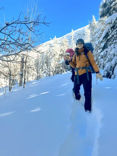 Young woman on a mountain in the snow