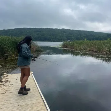 Nina fishing off of a dock.