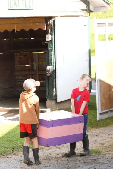 Two small 4-Hers carrying a very heavy platform