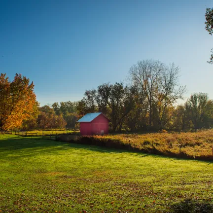 Vermont field with a small red barn.