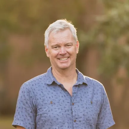 Headshot of a person in a blue shot