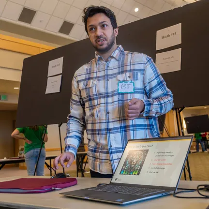 A Computer Science graduate student shares his project during the Computer Science Fair