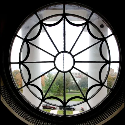 View of greenspace through a circular decorative window