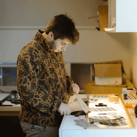 A student examines film on a lightbox