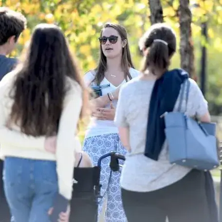 Student giving a campus tour to prospective students and families.