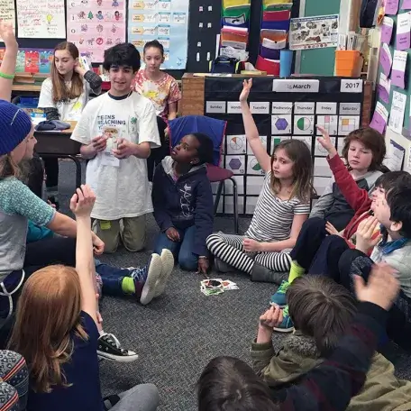 a teenage student teaching a bunch of pre-teen students