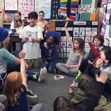 a teenage student teaching a bunch of pre-teen students