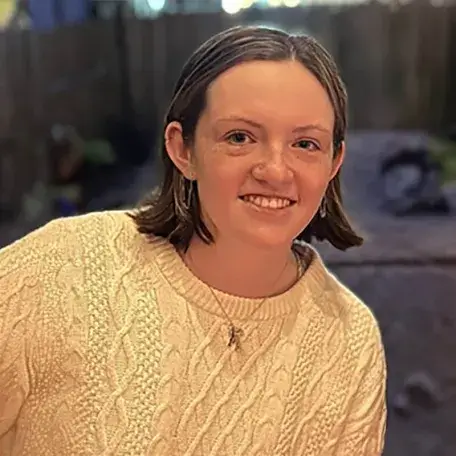 A profile image of a person with beige shirt