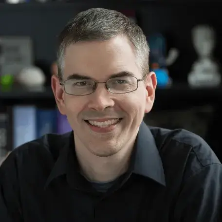 Keith, smiling for the camera in an office type setting