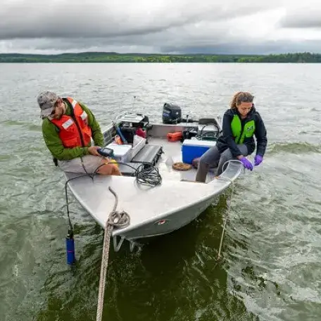Graduate students on a boat conducting water sampling