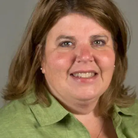 Denise, smiling and brilliant in green