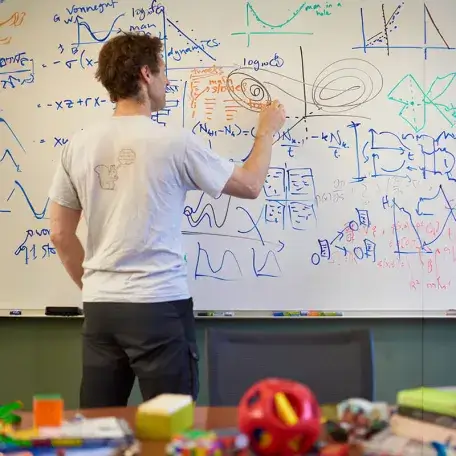 Professor writing on a white board